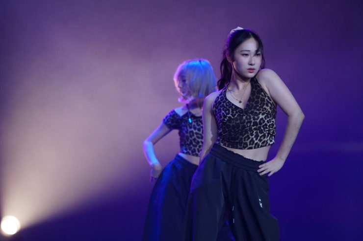 K-POPダンスショーケースイベント「Dance it UP」静岡開催のステージ写真。スポットライトに照らされた女性ダンサーが力強くパフォーマンスを披露している。